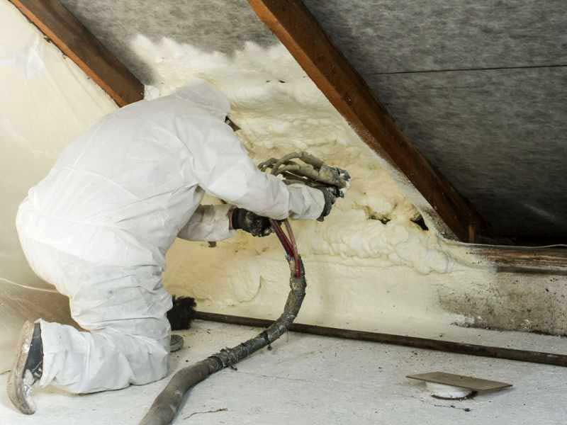 Insulation Installer insulating home's attic.