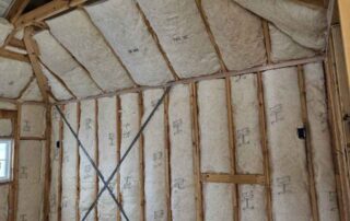 Fiberglass batt insulation on ceiling rafters and wall framing. Fiberglass batt insulation on ceiling rafters and wall framing.