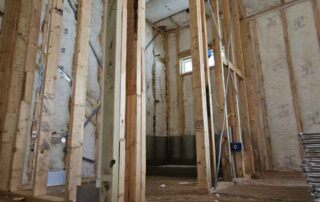 Interior stud wall framing with fiberglass batt insulation. Interior stud wall framing with fiberglass batt insulation.