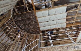 Fiberglass batt insulation in ceiling cavity. Fiberglass batt insulation in ceiling cavity.